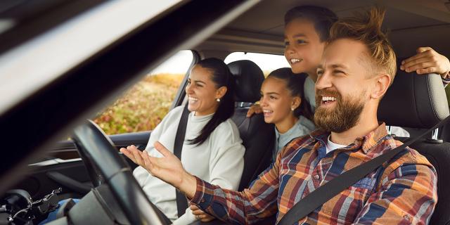 Familia feliz, dentro de un vehículo